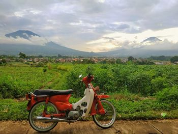 Bicycles on field against sky