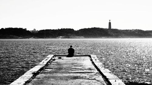 Rear view of silhouette man against clear sky