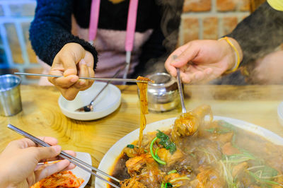 Close-up of family eating traditional korea food,ginseng chicken soup