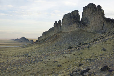 Rock formations on landscape against sky