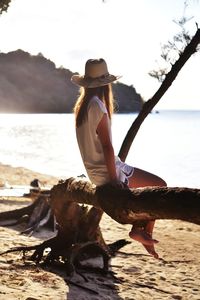 Full length of young woman standing on beach