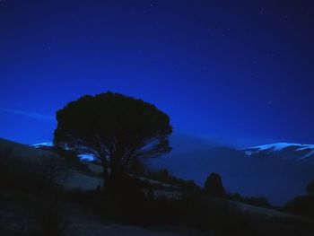 Scenic view of mountains against blue sky at night