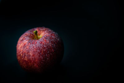 Close-up of apple against black background