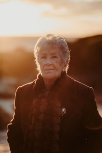 Portrait of woman standing against blurred background