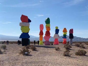 Stack of stones on desert against sky