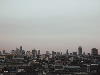 Buildings in city against clear sky