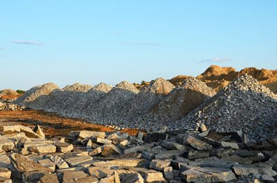 Scenic view of rocks against blue sky