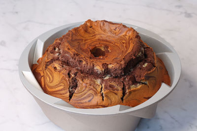 Close view of marbled cake texture with vanilla and cocoa on marble background