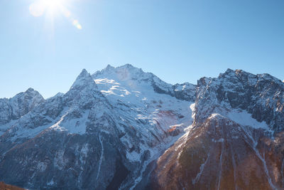 Panoramic view of snowcapped mountains against clear sky