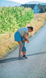 Full length of woman walking on road