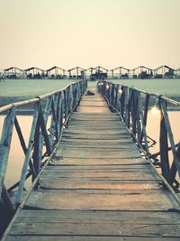 Pier over sea against clear sky