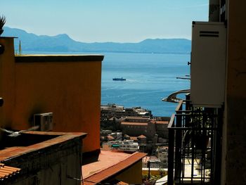 Townscape by sea against sky