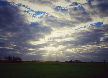 Scenic view of landscape against cloudy sky