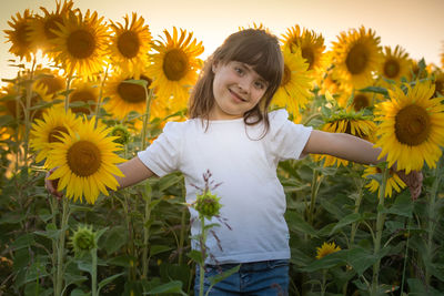 Low angle view of girl on sunflower field