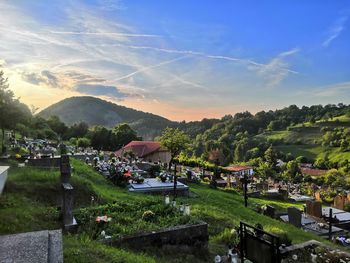 Panoramic view of houses and trees against sky