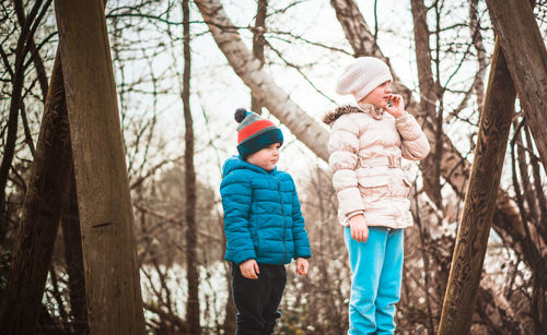 Full length of kids standing outdoors 