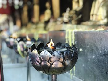 Close-up of burning candles in temple