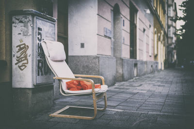 Empty chair against built structure