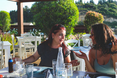 Smiling friends sitting at restaurant