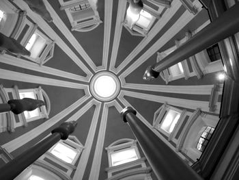 Low angle view of illuminated pendant lights hanging from ceiling