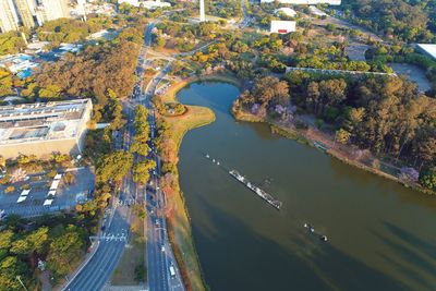 High angle view of river amidst trees in city