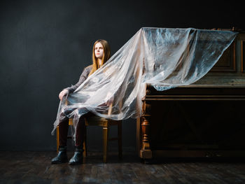 Portrait of woman sitting on chair