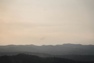 Scenic view of silhouette mountains against sky