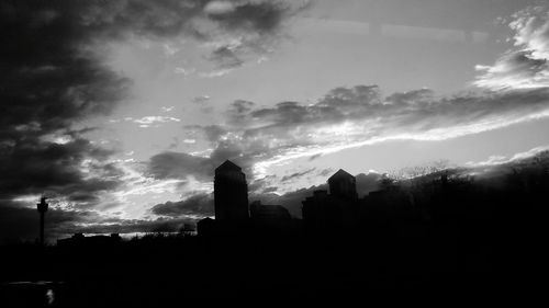 Silhouette trees against cloudy sky