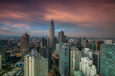 Aerial view of city buildings during sunset