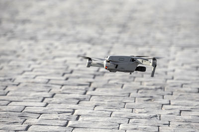 Drone landing, hovering above the tiles outdoor