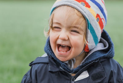 Close-up of cute girl in warm clothing with mouth open standing outdoors