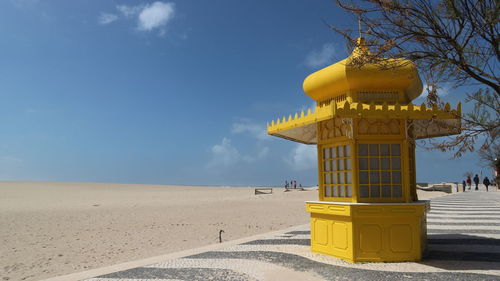 Lifeguard hut on beach against sky