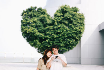Young couple in front of tree