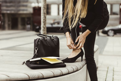 Businesswoman wearing high heels while standing outdoors