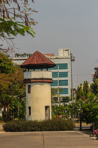 House by building against sky