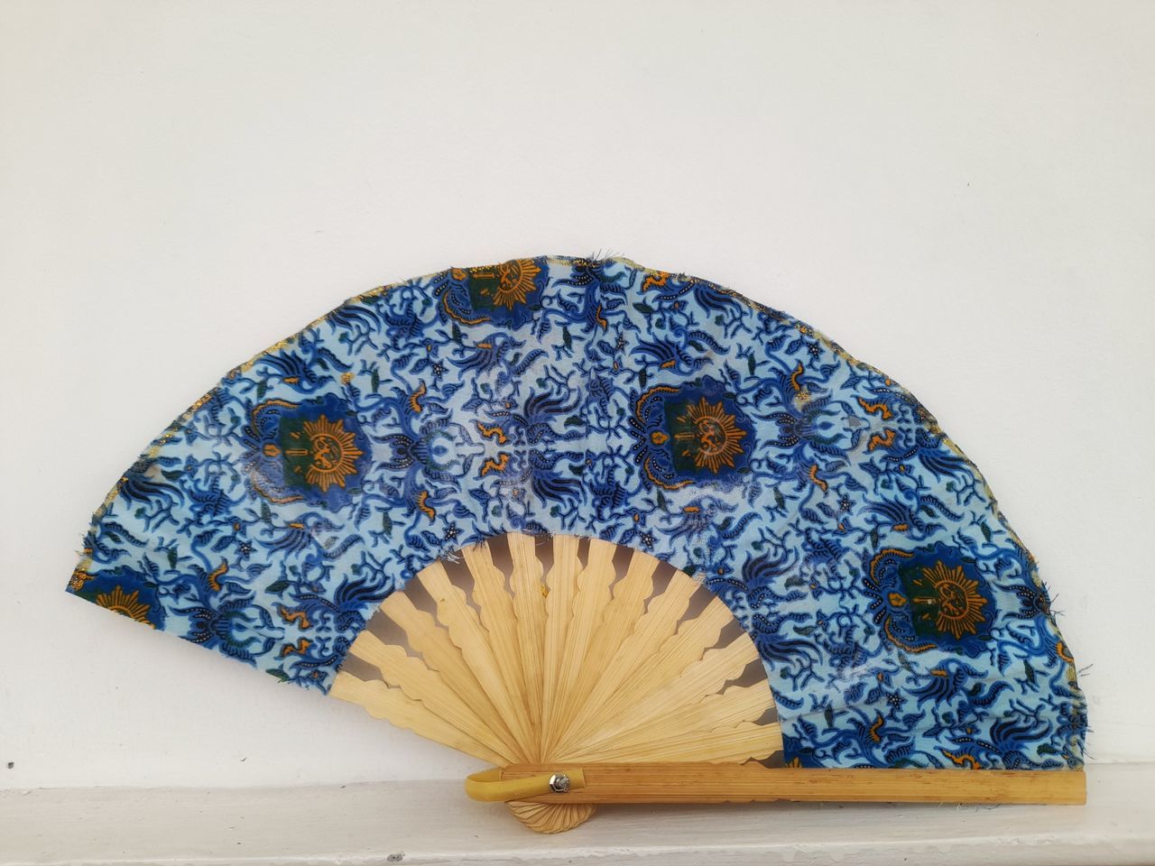 CLOSE-UP OF MULTI COLORED UMBRELLA ON TABLE