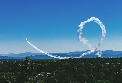 Scenic view of mountains against blue sky