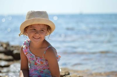 Portrait of smiling girl standing at beach