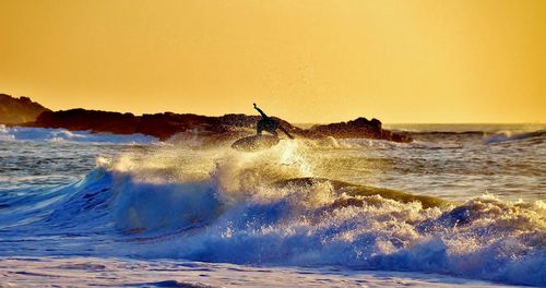 Waves splashing on rocks at beach