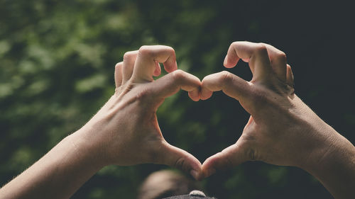 Close-up of hands holding heart shape