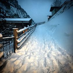 Snow covered landscape against sky