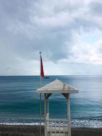 Lifeguard hut on beach against sky