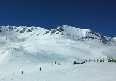 Tourists on snow covered mountain