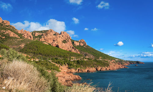 Scenic view of sea and mountains against sky