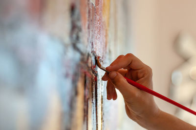 Close-up of hand holding painting