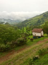 Houses on field against mountains