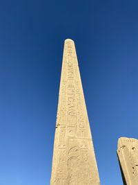 Low angle view of building against clear blue sky