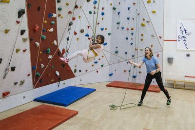 Mother with daughter in climbing gym