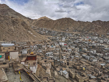 High angle view of townscape and mountains against sky