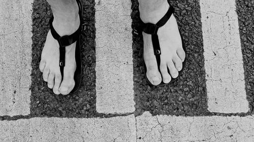 Low section of man standing on ground